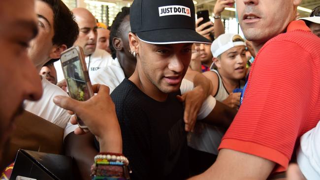 Barcelona's Brazilian forward Neymar is mobbed in Miami.