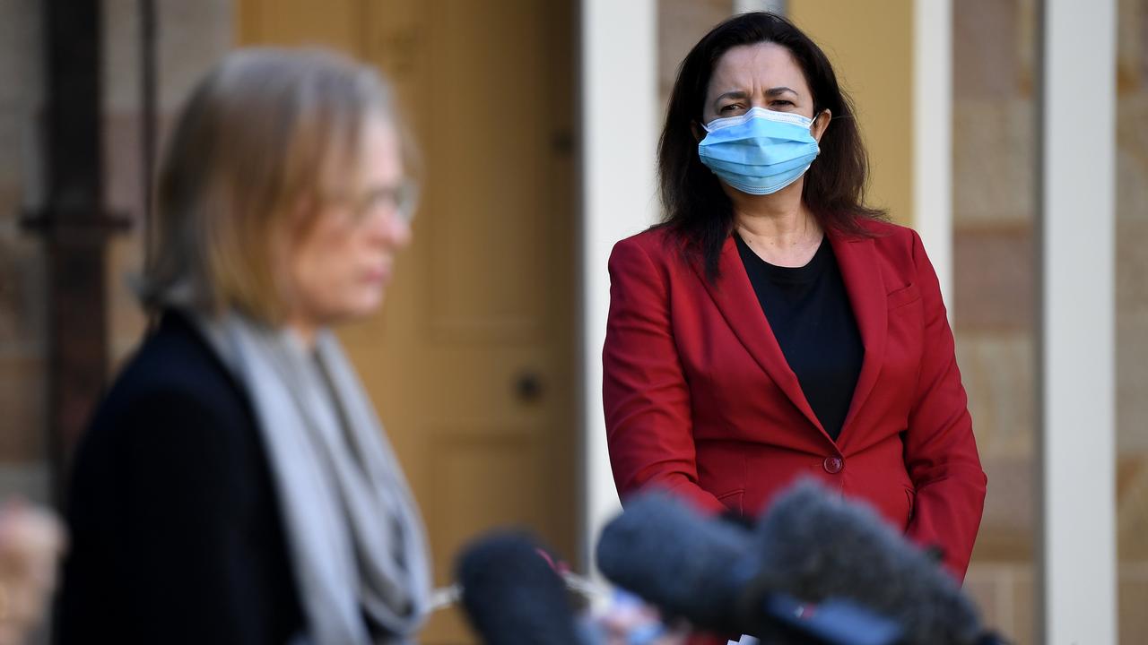 Queensland Premier Annastacia Palaszczuk watches chief health officer Dr Jeannette Young during a media conference, to provide a Covid-19 update. Picture: NCA NewsWire / Dan Peled