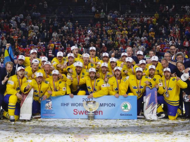 Sweden's players pose with the trophy.