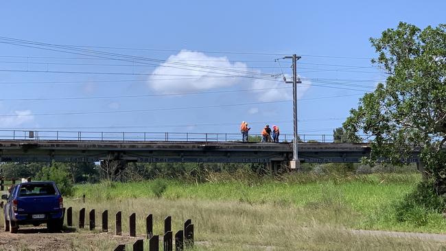 Police and Aurizon staff inspecting the train bridge at Gladstone where the incident occurred.