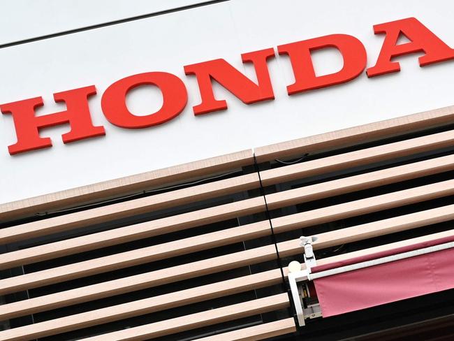 A Honda logo is pictured as cars are displayed outside a Honda showroom of companyâs headquarters in Tokyo on November 6, 2020. (Photo by Philip FONG / AFP)