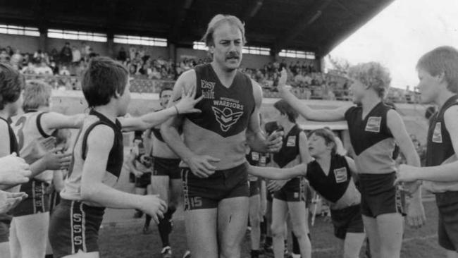 Malcolm Blight leads Woodville on to the ground for his last match at Woodville Oval in 1985.