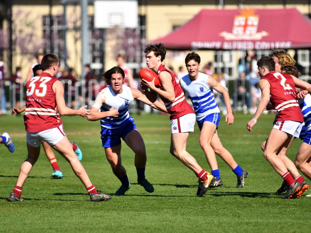 Prince Alfred’s Wil Bromley has the ball under pressure against St Peter’s. Picture: AAP/ Keryn Stevens.