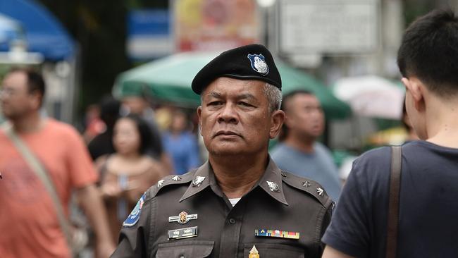 A Thai policeman patrols near the Erawan Shrine, the site of a bombing in August 2015 that left 20 dead and scores injured, in the centre of Bangkok on August 13, 2016. Picture: AFP.