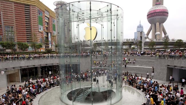 Customers queue to enter an Apple flagship store, in Shanghai, China. Picture: AP