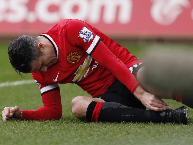 Manchester United's Dutch striker Robin van Persie reacts during the English Premier League football match between Swansea and Manchester United at the Liberty Stadium in Swansea, south Wales on February 21, 2015. Swansea won the match 2-1. AFP PHOTO / JUSTIN TALLIS RESTRICTED TO EDITORIAL USE. NO USE WITH UNAUTHORIZED AUDIO, VIDEO, DATA, FIXTURE LISTS, CLUB/LEAGUE LOGOS OR "LIVE" SERVICES. ONLINE IN-MATCH USE LIMITED TO 45 IMAGES, NO VIDEO EMULATION. NO USE IN BETTING, GAMES OR SINGLE CLUB/LEAGUE/PLAYER PUBLICATIONS.