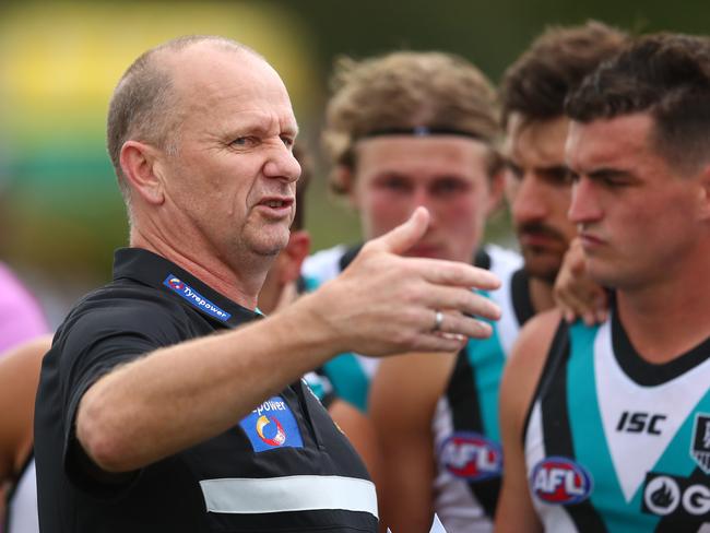 BRISBANE, AUSTRALIA - FEBRUARY 23: Power coach Ken Hinkley talks to players during the 2020 Marsh Community AFL Series match between the Brisbane Lions and the Port Adelaide Power at Moreton Bay Sports Complex on February 23, 2020 in Brisbane, Australia. (Photo by Chris Hyde/AFL Photos/Getty Images)