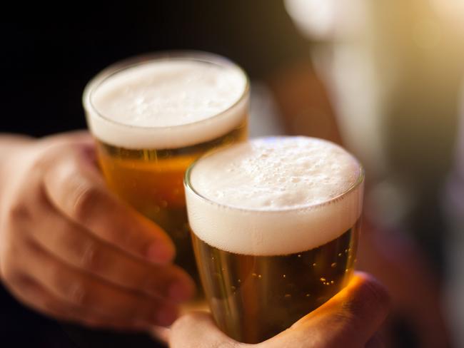 Cheers! Clink glasses. Close-up shots of hands holding beer glasses and beer bubbles.