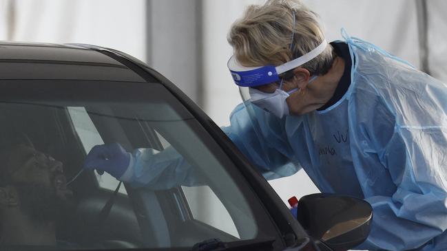 MELBOURNE, AUSTRALIA - NewsWire Photos AUGUST 20, 2021: People receive COVID tests in a drive through COVID testing centre next to the Palais Theatre at St Kilda. Picture: NCA NewsWire / Daniel Pockett