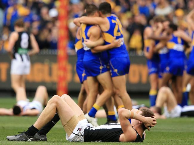 Eagles players celebrate as Mason Cox collapses on the siren. Picture: Mark Stewart