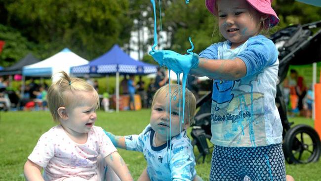 Elizabeth Ladewig, Clay and Ivy Payne get messy at the Botanic Gardens. Picture: Jann Houley