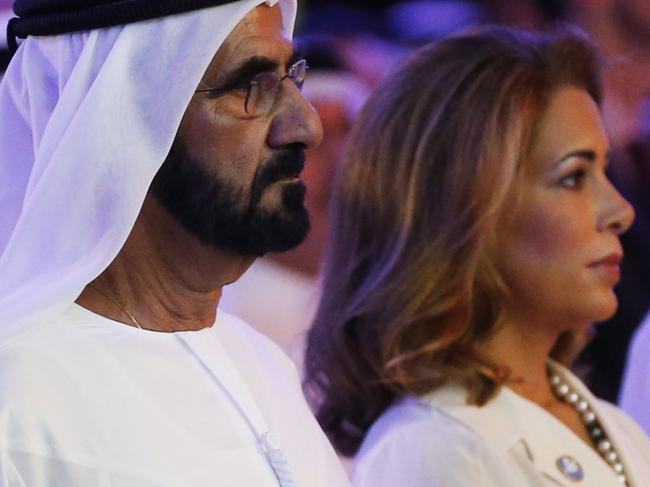 UAE Prime Minister and Dubai Ruler Sheikh Mohammed bin Rashid al-Maktoum (L) stands next to his wife Princess Haya bint al-Hussein during the presentation of a UN report on funding for humanitarian aid on January 17, 2016, in the Emirate of Dubai. / AFP / STRINGER