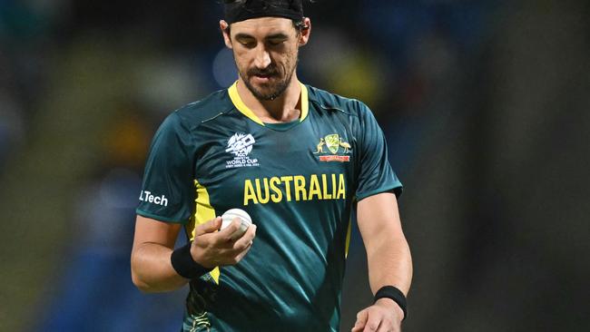 Australia's Mitchell Starc checks the ball before bowling during the ICC men's Twenty20 World Cup 2024 Super Eight cricket match between Australia and Bangladesh at Sir Vivian Richards Stadium in North Sound, Antigua and Barbuda, on June 20, 2024. (Photo by ANDREW CABALLERO-REYNOLDS / AFP)