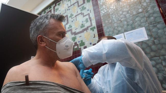 A man is vaccinated in Vienna, Austria, where the President has signed a law making Covid-19 vaccination mandatory for all adults, a first in the European Union. Picture: Alex Halada / AFP