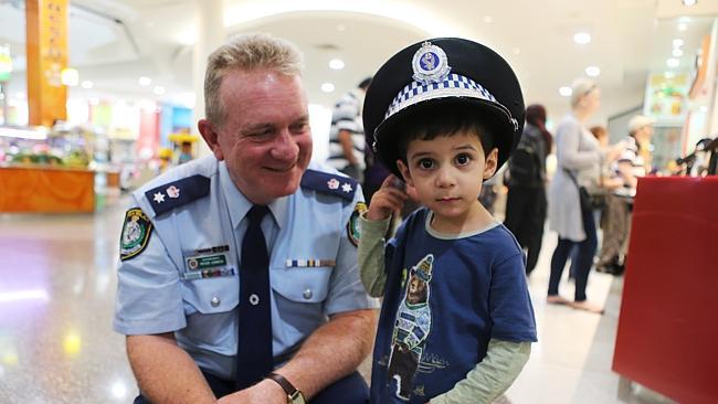 Ordel Hermizi tries on Fairfield police Supt Peter Lennon’s hat during a visit to Fairfield shopping centre.