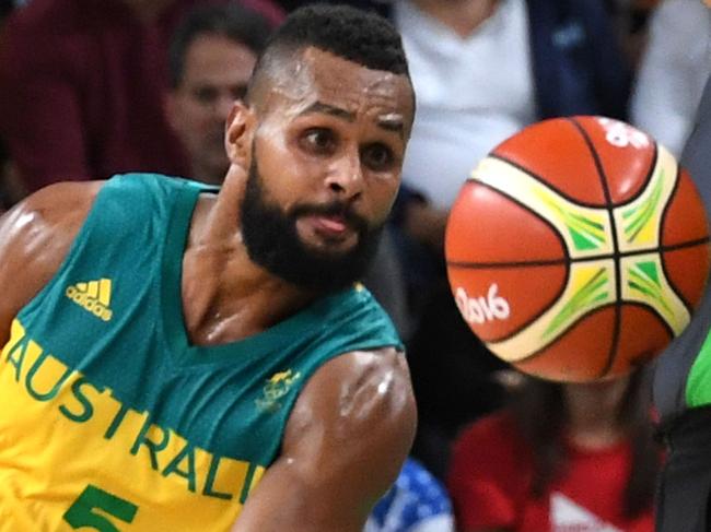 Australia's guard Patty Mills watches the ball go out of play during a Men's round Group A basketball match between Australia and USA at the Carioca Arena 1 in Rio de Janeiro on August 10, 2016 during the Rio 2016 Olympic Games. / AFP PHOTO / Mark RALSTON