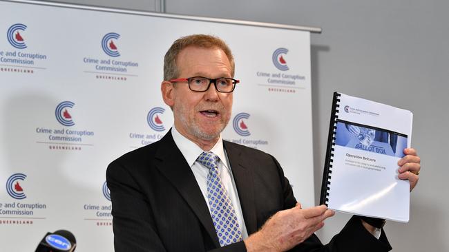 Queensland's Crime and Corruption Commission (CCC) chairman Alan MacSporran QC with the report from the Operation Belcarra investigation in 2017 investigating the conduct of candidates during the 2016 local government elections for the Gold Coast City Council, Moreton Bay Regional Council, Ipswich City Council and Logan City Council. (AAP Image/Darren England)