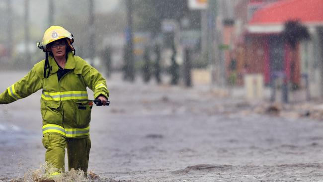 Floods North West Tasmania, Railton, a Tasmania Fire Service (TFS) firefighter wades through water.