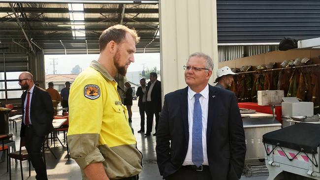 Prime Minister Scott Morrison visits the Huonville Fire Station and talks to a firefighter from NSW. Picture: LUKE BOWDEN