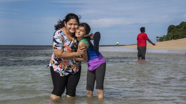 Indian tourists Netania Barot (11) and mum Bijal Barot, paddle in the Coral Sea at Green Island. during a day trip. Photo: Brian Cassey