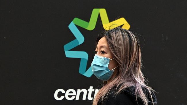 A woman waits in a queue to receive benefit payouts, including unemployment and small business support, at a Centerlink payment centre in downtown Sydney. Picture: Saeed Khan/ AFP