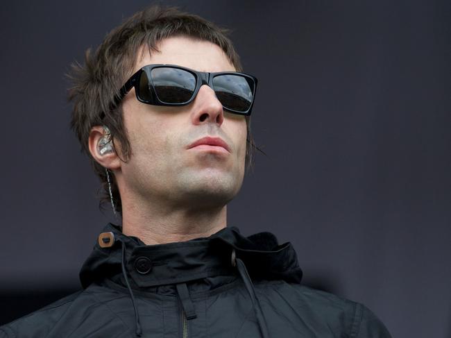 (FILES) This file photo taken on June 28, 2013 shows British singer Liam Gallagher gesture to the crowed while performing with his band Beady Eye on third day of the Glastonbury Festival of Contemporary Performing Arts near Glastonbury, southwest England. Oasis frontman Liam Gallagher on May 26, 2017 announced his solo debut with a concert in his native Manchester to support families affected by the deadly suicide attack at the city's arena. / AFP PHOTO / ANDREW COWIE