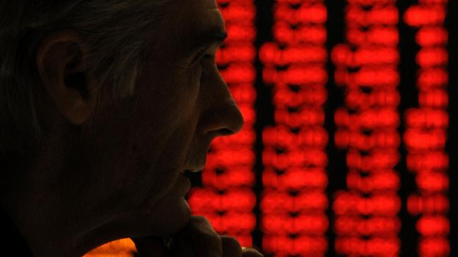 19/05/2010 WIRE: A concerned investor looks at a sea of red (indicating falling share prices) on a display at the Australian Stock Exchange (ASX) in Sydney 19/05/2010.