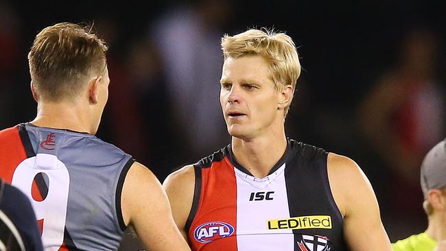 Brendon Goddard shakes hands with former teammate Nick Riewoldt in 2013.