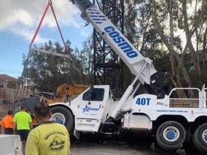 The crane which fell into a hole while carrying an excavator.