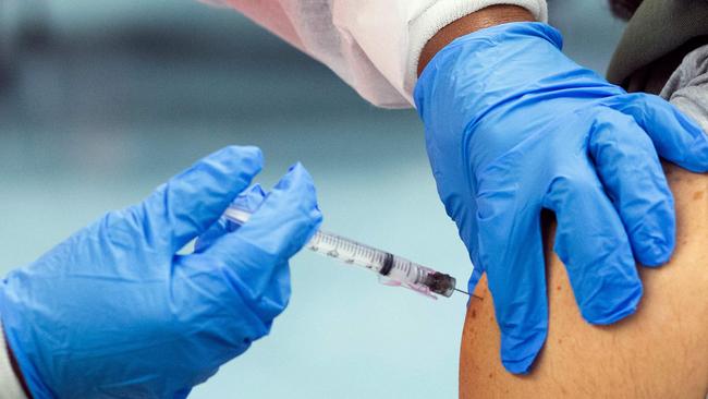 Those wanting to home quarantine in Queensland as part of a trial must be fully vaccinated at least two weeks before they fly home. Picture: Kena Betancur/AFP