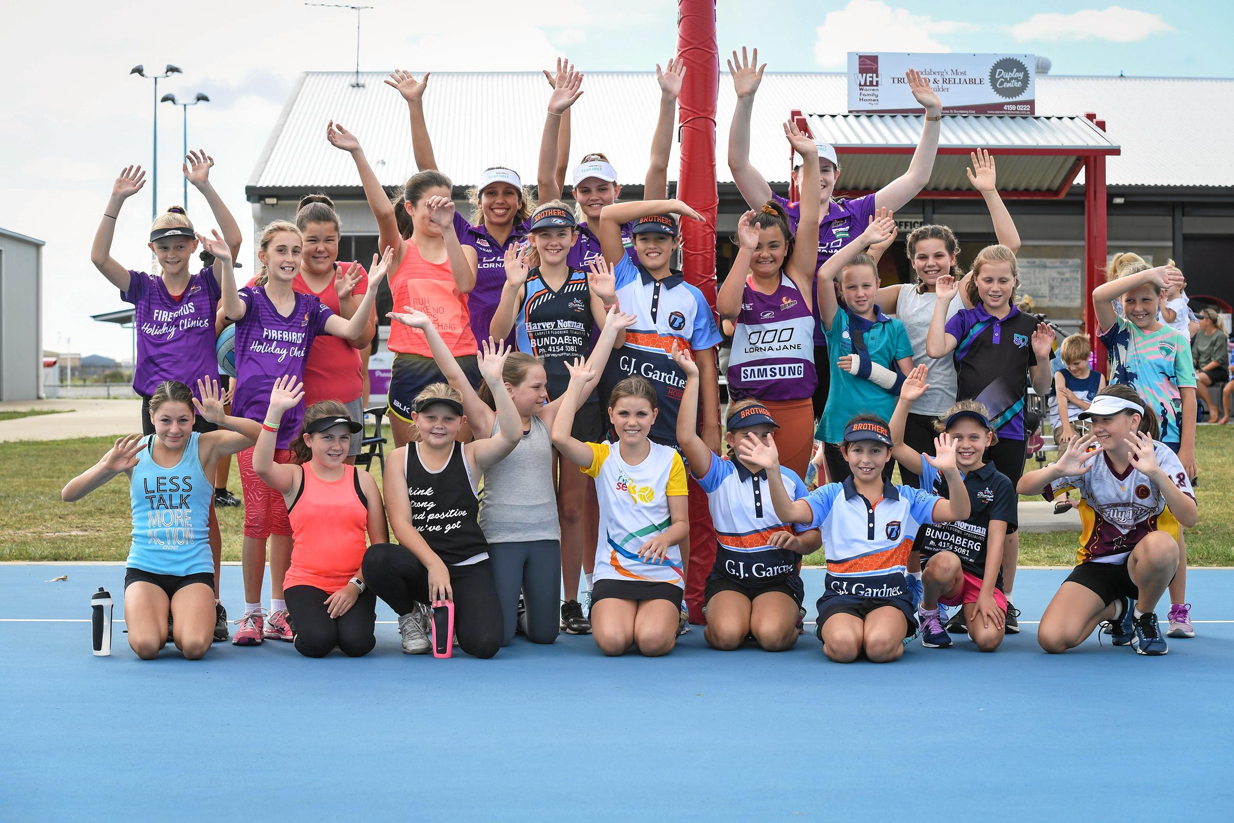 Jemma Mi Mi, Tippah Dwan and Tarah Hinchliffe at the back with their admiring fans at the Bundaberg Netball Clinic. Picture: Brian Cassidy