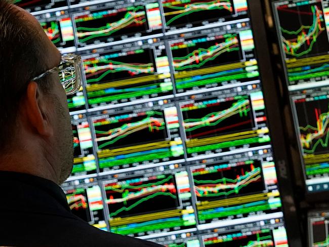 A trader works at his desk on the floor of the New York Stock Exchange (NYSE) during the first session of the new year on January 2, 2025, in New York City. (Photo by TIMOTHY A. CLARY / AFP)