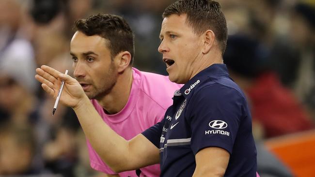 Brendon Bolton talks with runner Andrew Walker. Picture: Michael Klein