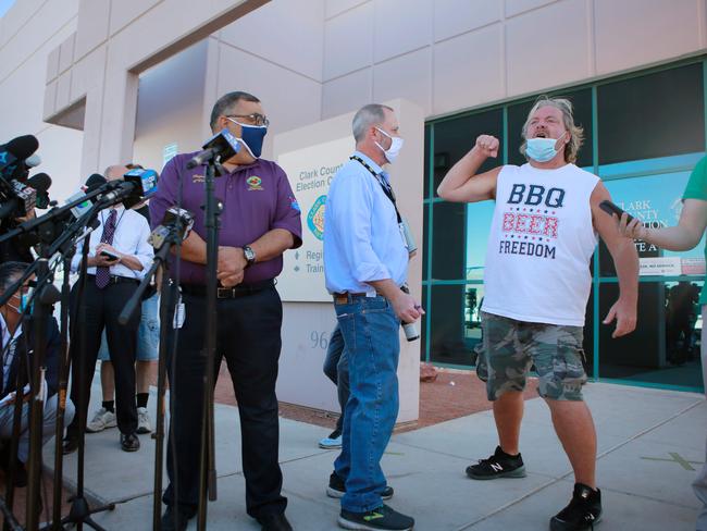 Clark County Registar of Voters Joe Gloria, left, is interrupted by a disgruntled member of the public during a press conference outside Clark County Election Department in North Las Vegas, Nevada. Picture: Ronda Churchill / AFP