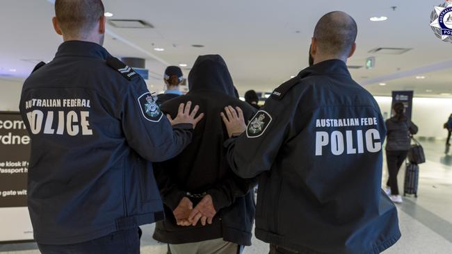 AFP officers arrest Guy Habkouk at Sydney International Airport on May 27 following his deportation from Turkey. Picture: AFP