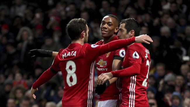 Manchester United's Anthony Martial (C) celebrates scoring.