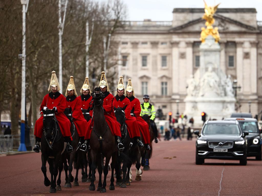 Life Guards, a unit of the Household Cavalry ride their horses past Buckingham Palace in London on February 6. Picture: Henry Nicholls / AFP