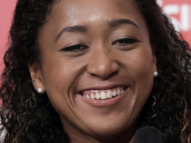 YOKOHAMA, JAPAN - SEPTEMBER 13: 2018 US Open Women's Singles champion Naomi Osaka of Japan reacts as she speaks during a press conference on September 13, 2018 in Yokohama, Kanagawa, Japan. (Photo by Kiyoshi Ota/Getty Images)