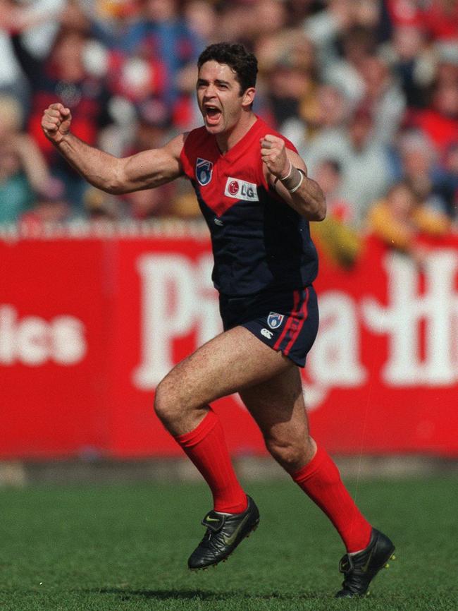 Garry Lyon celebrates after kicking a goal in the opening minute of a match.