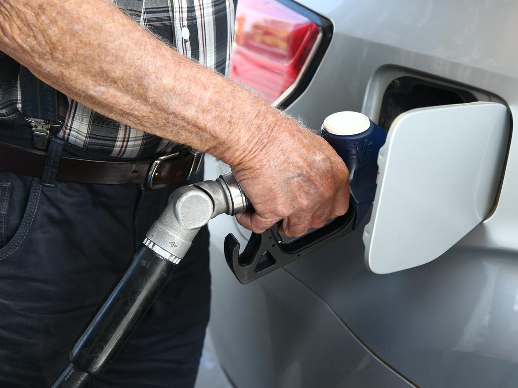 A motorist fills his car up with fuel from the petrol bowser at the United service station on Sheridan Street. PICTURE: BRENDAN RADKE