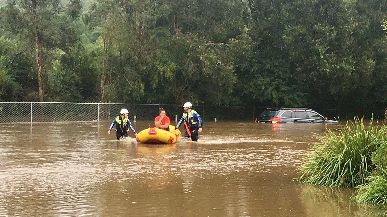 A woman is rescued from her car stuck in flood water. Picture: Central Coast Volunteer Rescue Association