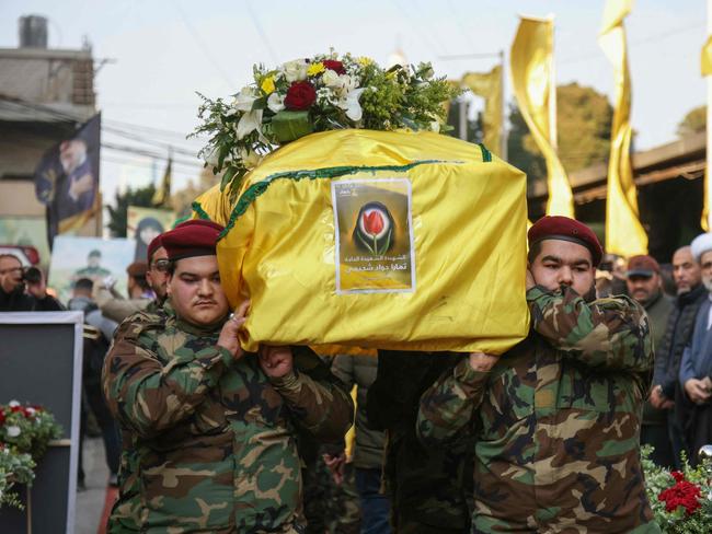 Members of Lebanon's Hezbollah group alongside family members and friends attend the funeral of people from southern villages who were killed in Israeli fire a day earlier as they tried returning to their towns, in Ghobeiri in Beirut's southern suburbs on January 27, 2025. (Photo by IBRAHIM AMRO / AFP)