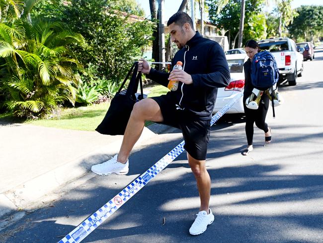 Justis Huni (left) steps over a police tape as he returns to his home in Sunnybank Hills, Brisbane. NCA NewsWire / Dan Peled