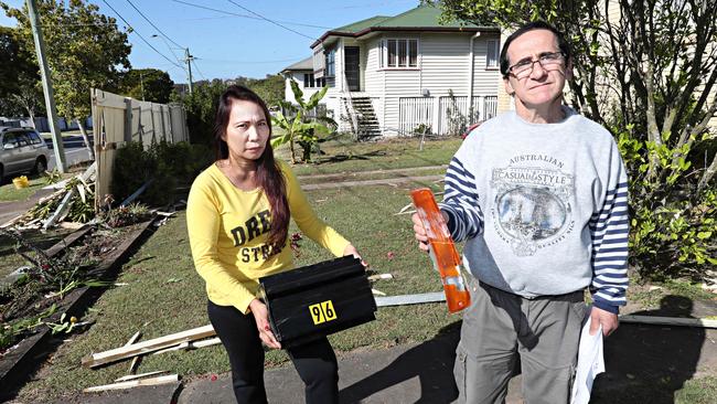 John and Amarlita Gomez clean up after the fatal crash. Picture: Annette Dew