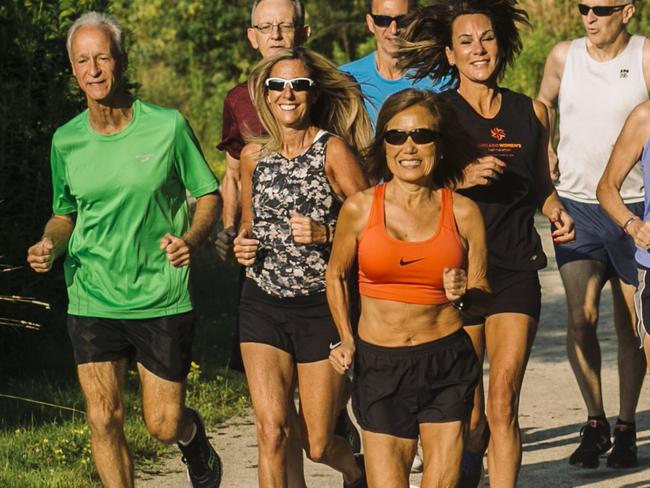 Jeannie Rice, center, runs with a running group in Perry, Ohio on July 26, 2019.Rice, now 71, has run more than 1,000 races including 100 marathons. Last year she set a world record in her age division in the marathon and she can still run a 7 minute 20 second mile, often passing men half her age in races. Published Credit: Andrew Spear for The Wall Street Journal