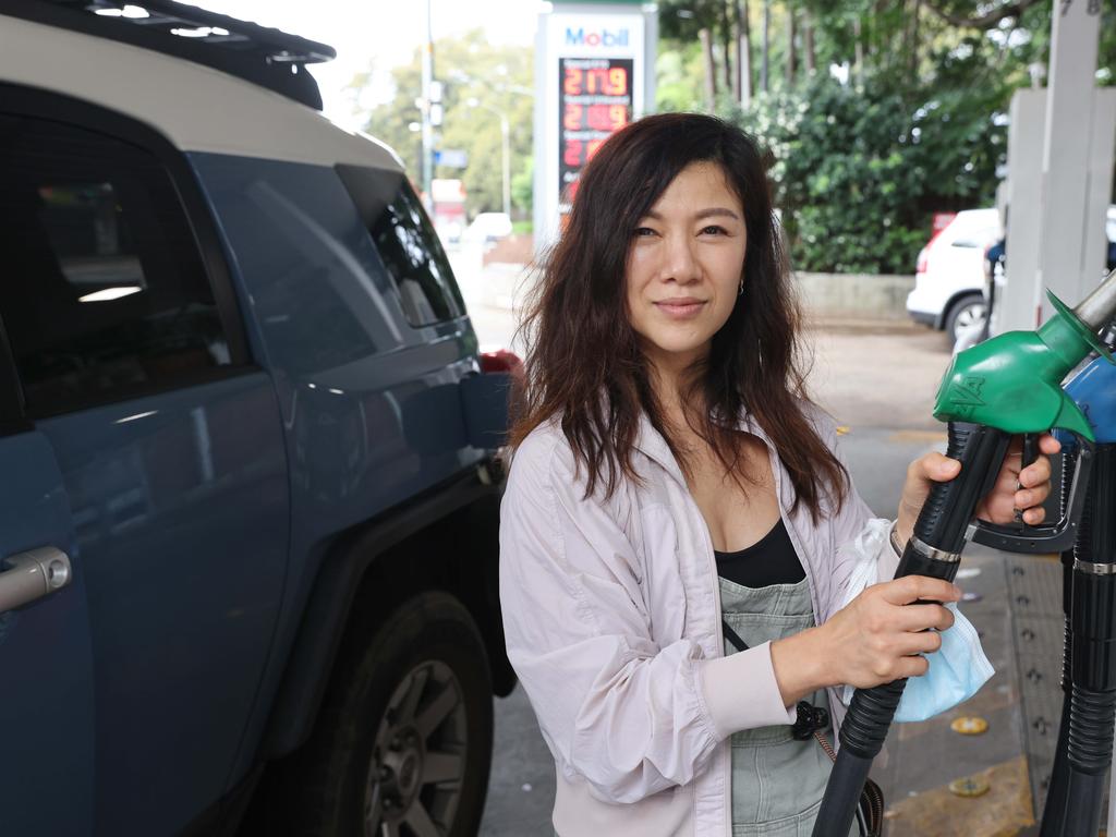 Winnie Lau filling up her car in Paddington today as petrol prices across Sydney are up over 2 dollars a litre. Picture: David Swift