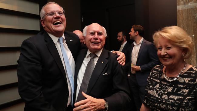 Prime Minister Scott Morrison with John Howard and his wife Janette on election night. Picture: Adam Taylor