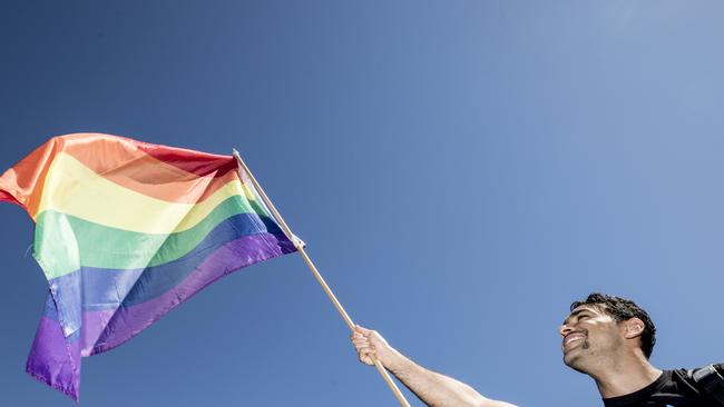 A man waves a rainbow flag in Sydney. Picture: Cole Bennetts/Getty Images