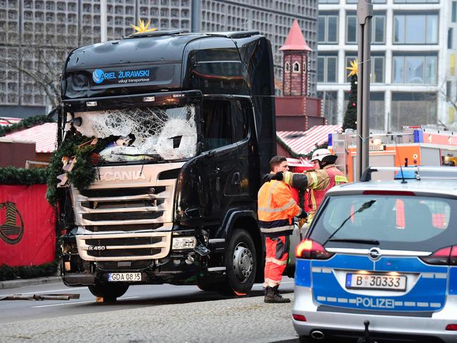 Workers prepare to tow the truck away. Picture: AFP