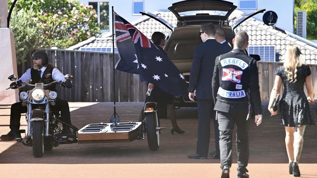 The casket was attached to a platform beside a lone rider.